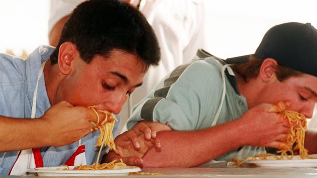 Doing battle in the Italian Festival spaghetti eating competition are David Crisafulli, the winner, and Paul Cosentino, taken in 1999. Picture: Scott Radford Chisholm