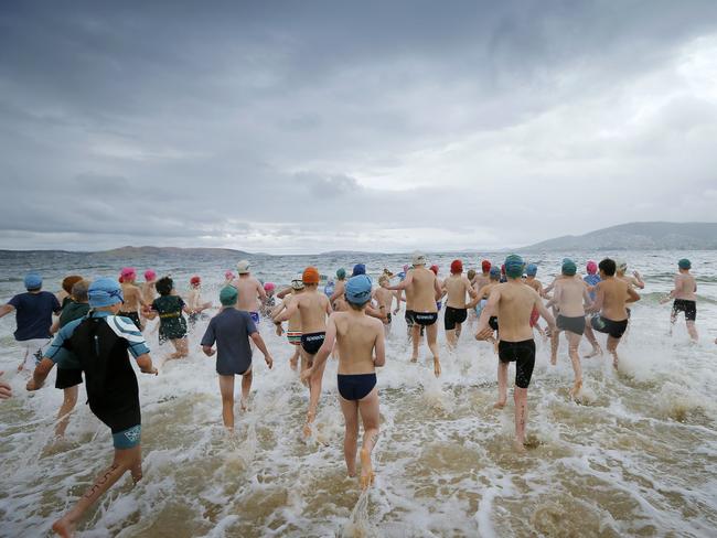 Boy run into the cold water for the grade 5 race.