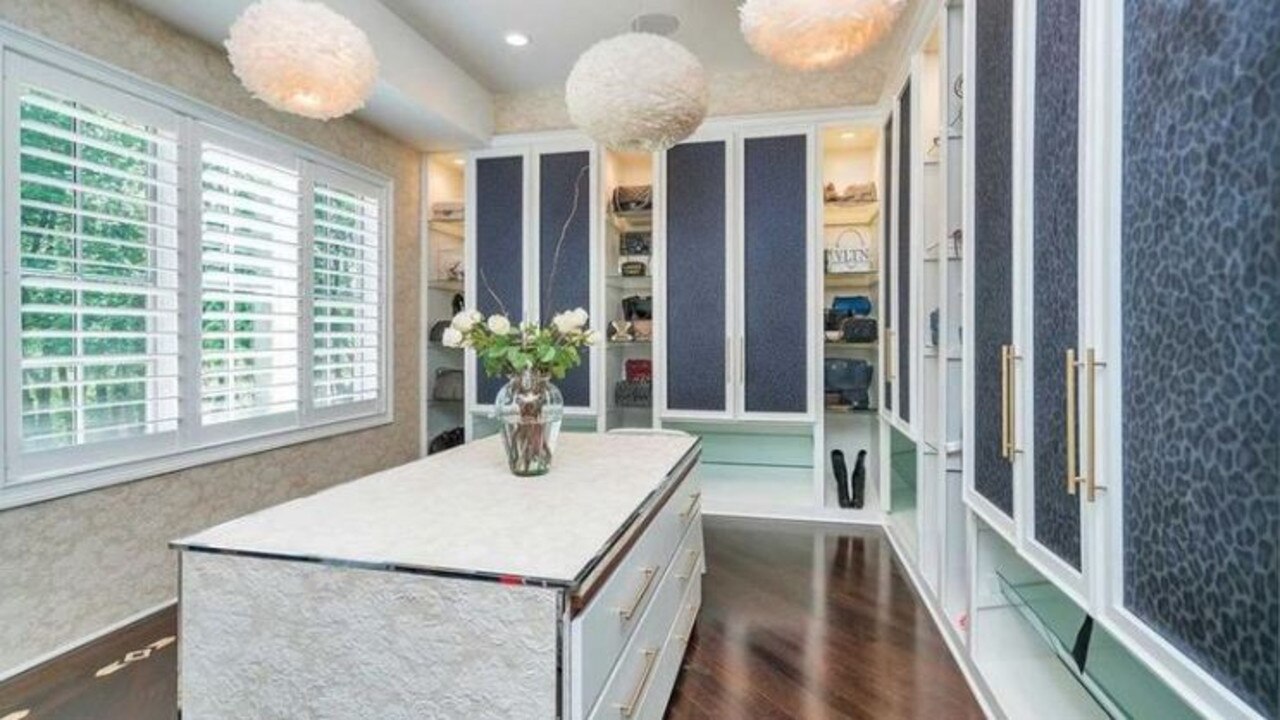 Do you have enough handbags to make full use of this walk-in wardrobe? Source: realtor.com