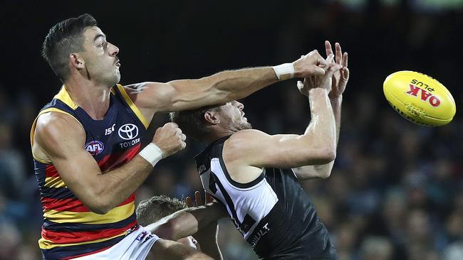 Crows skipper. Taylor Walker makes sure Tom Jonas can’t take a relieving mark. Picture: Sarah Reed