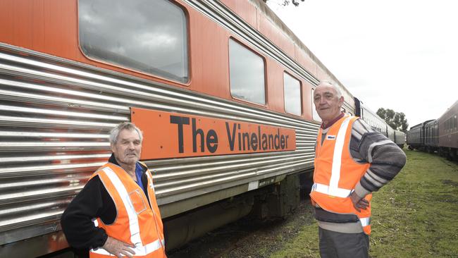 Malcolm Hillier and Bob Merlo next to an old Vinelander train 20 years after the service was cut.