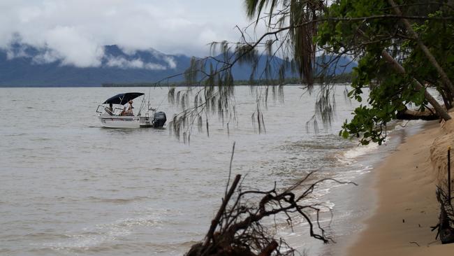 A boat in close to Holloways Beach shore fishing at the peak of an earlier king tide. Picture: Stewart McLean