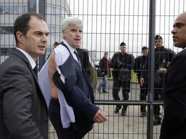 Shirty day ... Air France executive Pierre Plissonnier almost stripped bare by protesters. Picture: AFP//Kenzo Tribouillard