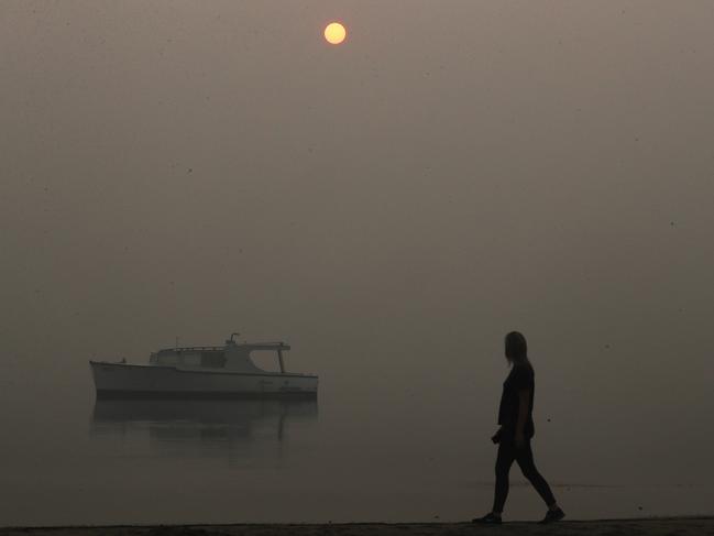 Thick smoke hangs over Lakes Entrance almost blocking the sun on January 4. Picture: David Crosling