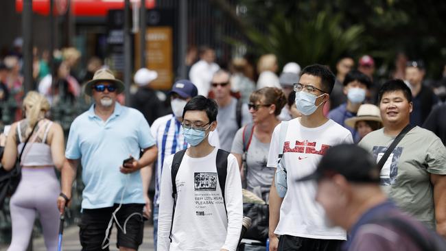 SYDNEY, AUSTRALIA - NewsWire photos NOVEMBER 21, 2022: People are seen wearing masks and choosing not to wear them at Circular Quay in Sydney. Picture: NCA NewsWire / Dylan Coker