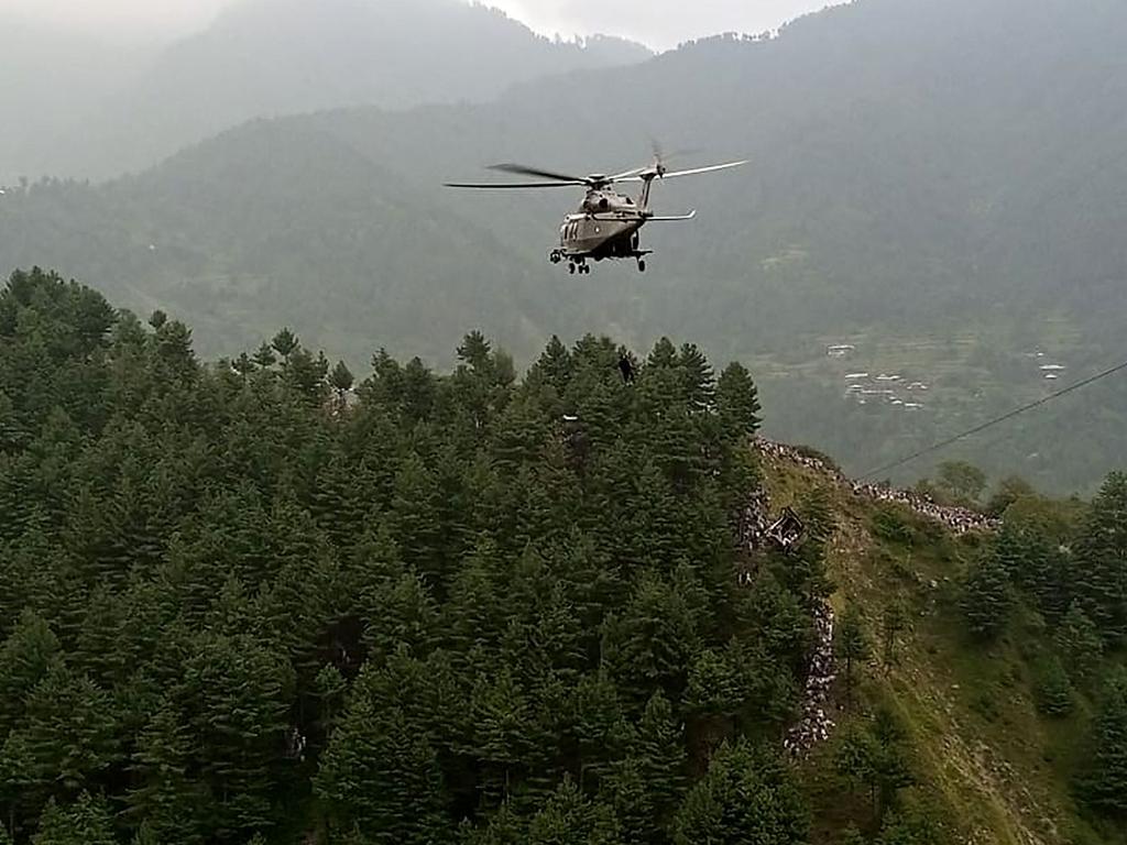 A military helicopter conducts a rescue operation to recover students stuck in a chairlift in the Pashto village of mountainous Khyber Pakhtunkhwa province. (Photo by AFP)