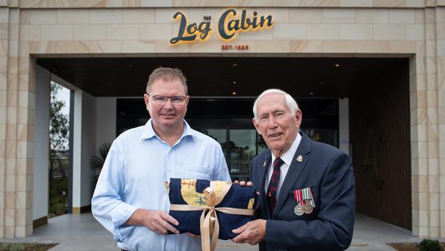 Former owner Ross Sinclair passes the baton to Craig Laundy- the hotel’s historic flag, which will go on display. Picture: Julian Andrews