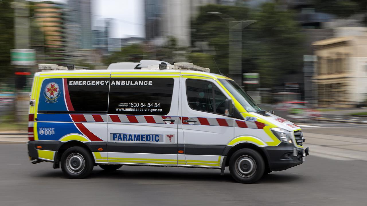 An ambulance speeds away from the Royal Melbourne Hospital. Ambulance, Generic. Picture: NCA NewsWire / David Geraghty