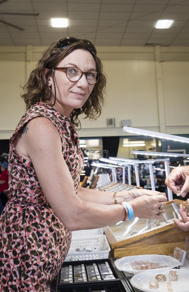 Nicole Cooper examines imperial topaz at a stall at Gemfest hosted by Toowoomba Lapidary Club at Centenary Heights State High School, Saturday, October 21, 2023. Picture: Kevin Farmer