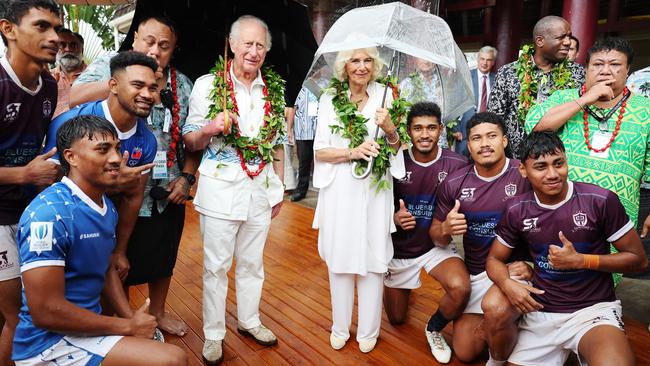 Charles and Camilla pose with local rugby union players during their Samoa Cultural Village visit on Thursday in Apia, Samoa. Picture: Getty Images