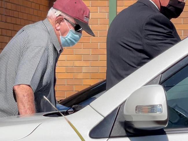 John Vincent Lewis hunched over outside Hervey Bay District Court.