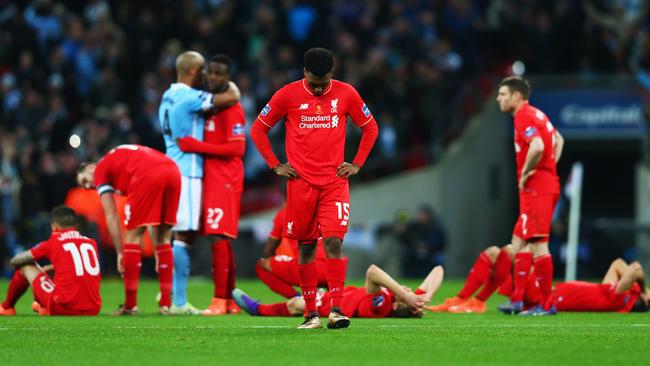 Daniel Sturridge of Liverpool (15) and team mates look dejected.