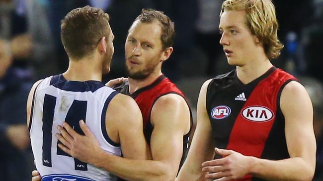 James Kelly gets a hug from former teammate Joel Selwood.