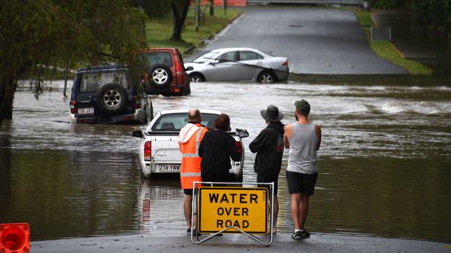 Cars partially submerged in floodwaters at Baratta St. Southport on Saturday. Picture: Steve Holland