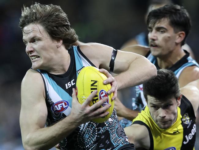 AFL - 08/06/18 - Port Adelaide v Richmond at The Adelaide Oval. Jared Polec sprint away from Trent Cotchin. Picture Sarah Reed