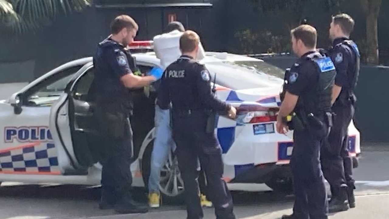 A man is arrested by police after a stabbing at Surfers Paradise that has left one man fighting for life. Picture: Greg Stolz