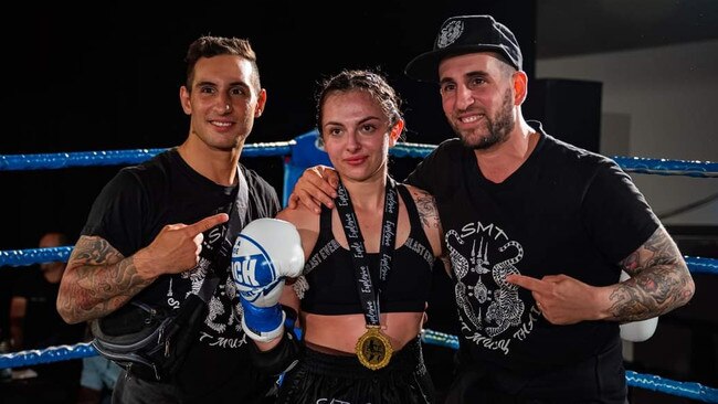 Shakayla Pefrola celebrates her victory with coaches from SMT Gym Mareeba. Picture: Emily Barker