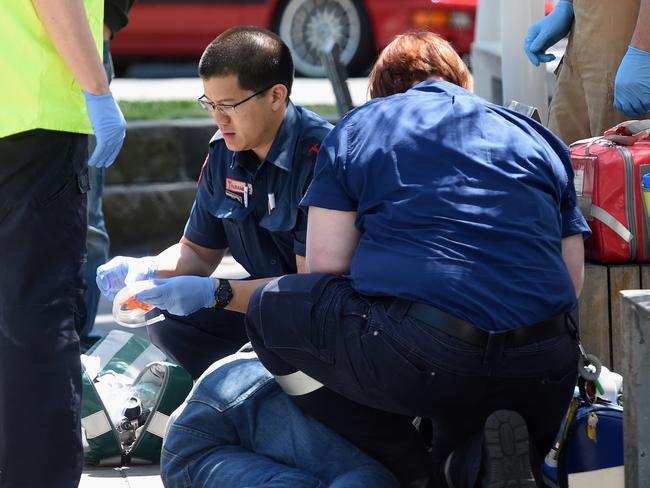 Paramedics work on a man for a suspected overdose on Lennox St. Picture: Nicole Garmston