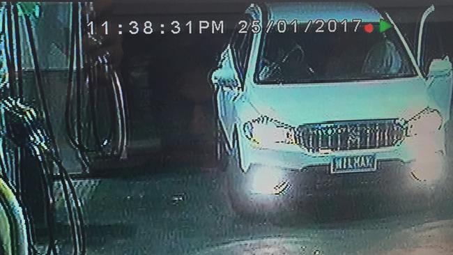 The stolen white SUV captured on camera at a BP service station.