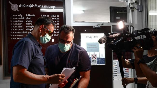 An Australian consular official talks to Andrew Neophitou in Bophut police station on Thailand's Koh Samui. Picture: AFP