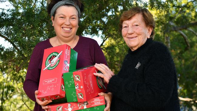 Mary Hartley, right, and her daughter Carmel pack shoeboxes with essentials for the needy. Picture: Joel Carrett