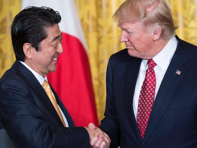 Japan's Prime Minister Shinzo Abe (L) and US President Donald Trump shaking hands. Picture: AFP