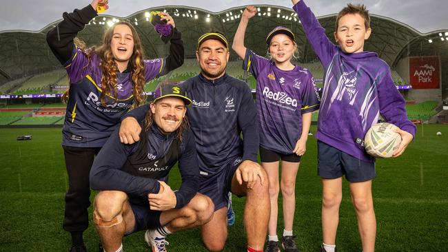 MELBOURNE, SEPTEMBER 11, 2024: Melbourne Storm training ahead their hosting an NRL qualifying final at AAMI Park on September 14, against the Cronulla Sharks. Ryan Papenhuyzen and Jahrome Hughes with fanes L to R Olivia, 12, Isabella, 11, and Aidan, 9. Picture: Mark Stewart