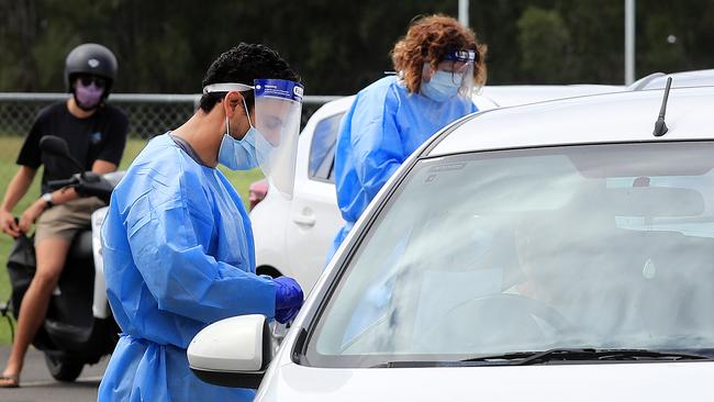 QML Pathology staff test Gold Coast locals who have to wait hours to be tested for Covid-19 at the Currumbin Eagles Rugby League Club which has turned into a Pop Up Testing. Picture: NCA NewsWire / Scott Powick