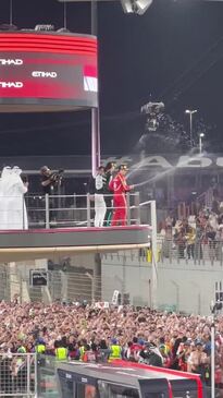 Brad Pitt celebrates on podium with F1 drivers