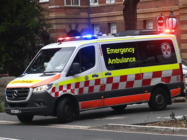 SYDNEY, AUSTRALIA -TelegraphMarch 21, 2022: An ambulance leaves the RPA Hospital as paramedics begin industrial action . Picture:  Jeremy Piper