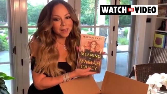 Mariah Carey holds her new memoir for the first time 