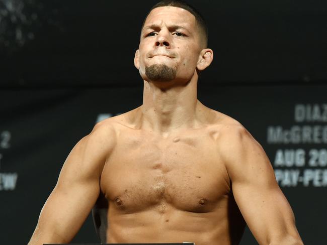 Nate Diaz poses on the scale during his weigh-in.