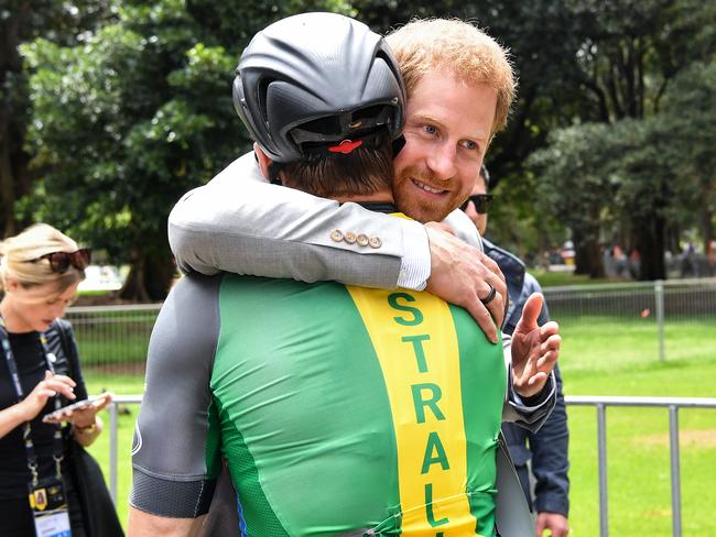 Prince Harry hugs Australian Invictus cyclist Michael Lyddiard. Picture: AAP