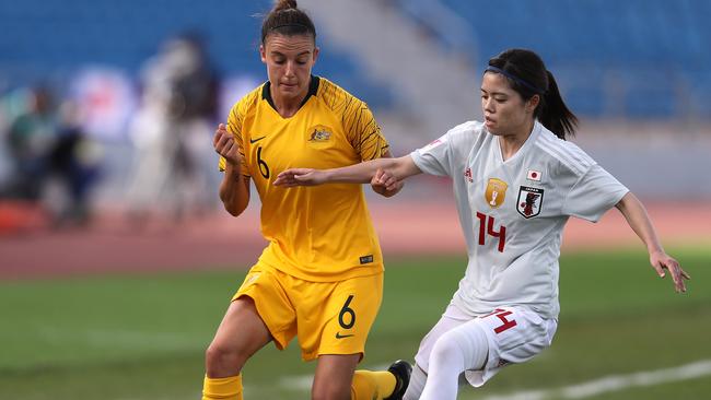 AMMAN, JORDAN - APRIL 13: Chloe Logarzo of Australia and Hasegawa Yui of Japan battle for the ball during the AFC Women's Asian Cup Group B match between Japan and Australia at the Amman International Stadium on April 13, 2018 in Amman, Jordan.  (Photo by Francois Nel/Getty Images)