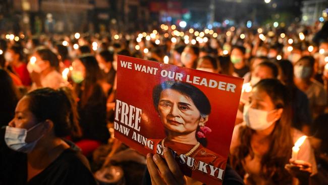 A protester holds a poster of Aung San Suu Kyi during a candlelight vigil to honour those who have died during demonstrations against the military coup in Yangon in 2021. Picture: AFP