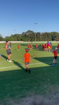 Toby Greene kicks footy with Concord Giants junior