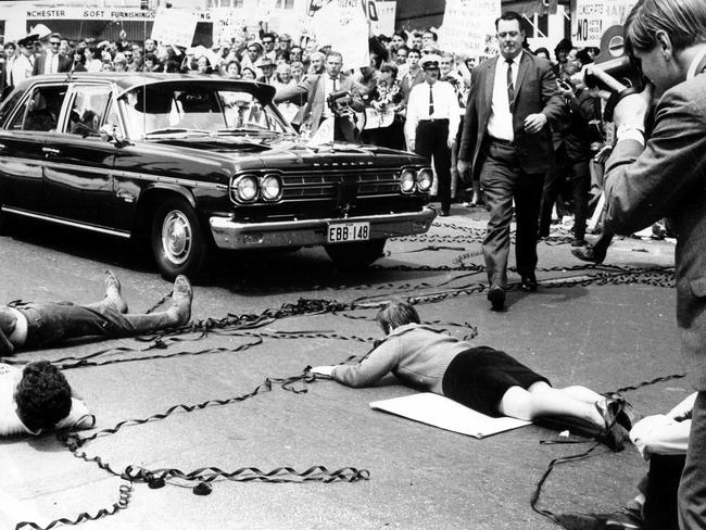 Anti-Vietnam war protesters lay on road blocking traffic in Sydney during protest rally in early 1970s.