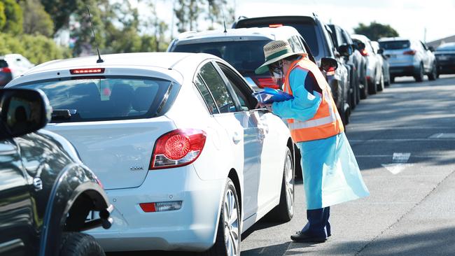 Motorists queue for a COVID-19 test near the Crossroads Hotel at Casula in Sydney’s southwest, where health workers tried to clear a big backlog. Picture: John Feder