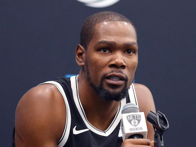 (FILES) In this file photo taken on September 26, 2019 Kevin Durant #7 of the Brooklyn Nets speaks to media during Brooklyn Nets Media Day at HSS Training Center on September 27, 2019 in the Brooklyn Borough of New York City. - Kevin Durant is among the four Brooklyn Nets players to test positive for the coronavirus, he told The Athletic on March 17, 2020. "Everyone be careful, take care of yourself and quarantine," Durant told The Athletic, adding that he is feeling fine and not showing any symptoms. "We're going to get through this." The Nets did not identify any players and said Tuesday that of the four players, only one is exhibiting symptoms. All four are isolated and are undergoing medical care from team physicians, the Nets said in a statement. (Photo by Mike LAWRIE / GETTY IMAGES NORTH AMERICA / AFP)