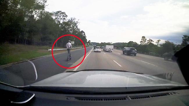 A man seen riding an escooter on the M1 in Helensvale on Friday December 1, 2023. Picture: Mark Boothman MP.