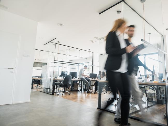 Business colleagues walking and talking  iStock office generic