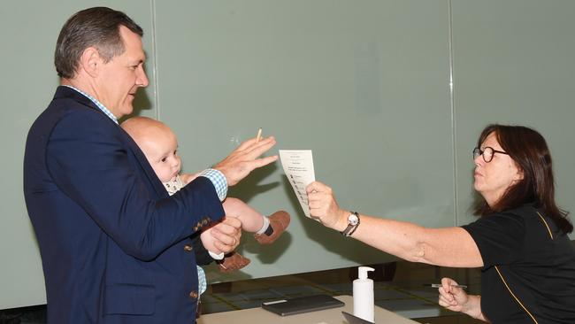 Chief Minister Michael Gunner, holding his son Hudson, places his vote this morning. Picture: Katrina Bridgeford