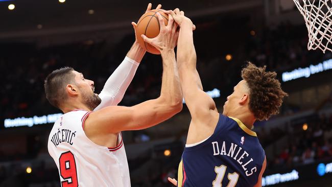 CHICAGO, ILLINOIS - OCTOBER 04: Dyson Daniels #11 of the New Orleans Pelicans blocks a shot by Nikola Vucevic #9 of the Chicago Bulls during the first half of a preseason game at the United Center on October 04, 2022 in Chicago, Illinois.NOTE TO USER: User expressly acknowledges and agrees that, by downloading and or using this photograph, User is consenting to the terms and conditions of the Getty Images License Agreement. (Photo by Michael Reaves/Getty Images)