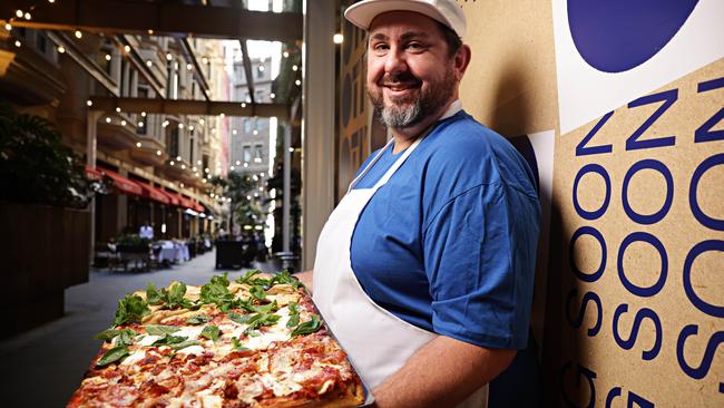 Chef Mike Eggert with some of his delicious creations out the front of his new pizza by the slice shop, Oti in Palings Lane Sydney. Picture: Adam Yip