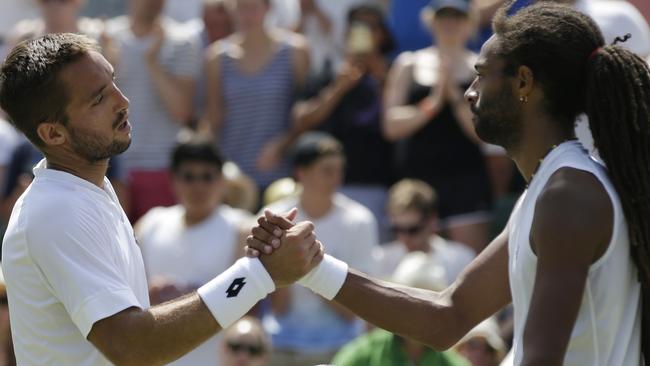 Viktor Troicki of Serbia, left, shakes hands after defeating Dustin Brown of Germany.