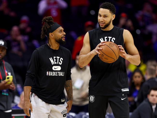 PHILADELPHIA, PENNSYLVANIA - MARCH 10:  Patty Mills #8 and Ben Simmons #10 of the Brooklyn Nets take the court for warm ups before the game against the Philadelphia 76ers at Wells Fargo Center on March 10, 2022 in Philadelphia, Pennsylvania. NOTE TO USER: User expressly acknowledges and agrees that, by downloading and or using this photograph, User is consenting to the terms and conditions of the Getty Images License Agreement. (Photo by Elsa/Getty Images)