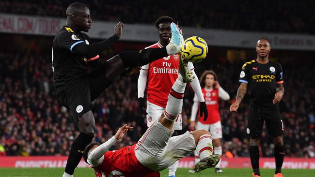 Manchester City defender Benjamin Mendy, left, vies with Arsenal Gabriel Martinelli