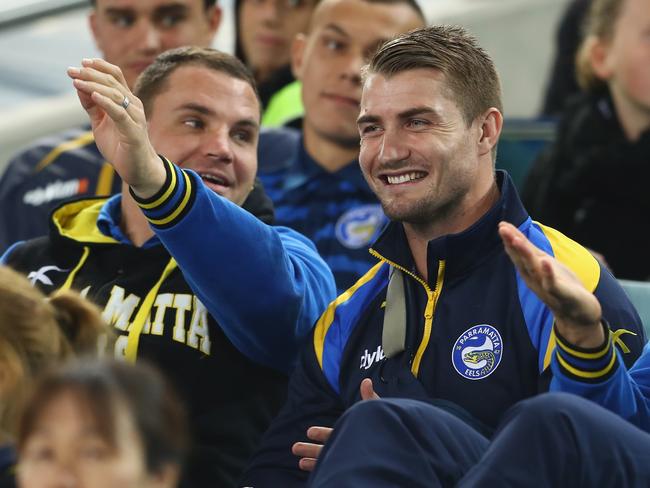 Anthony Watmough and Kieran Foran share a laugh as they watch the Eels from the stands.