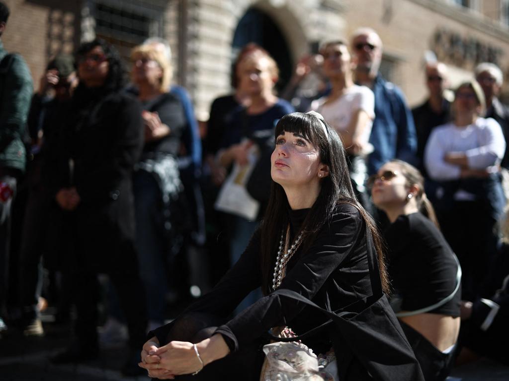 Mourners watch Francis’s funeral ceremony on a large screen in Via della Conciliazione street, near the Vatican in Rome. Picture: AFP
