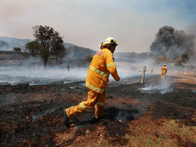 Helicopter water bombers drop water on properties in Hillville, NSW. Picture: Gary Ramage